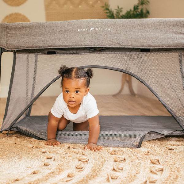 Baby in a Go With Me Nod Deluxe Portable Travel Crib